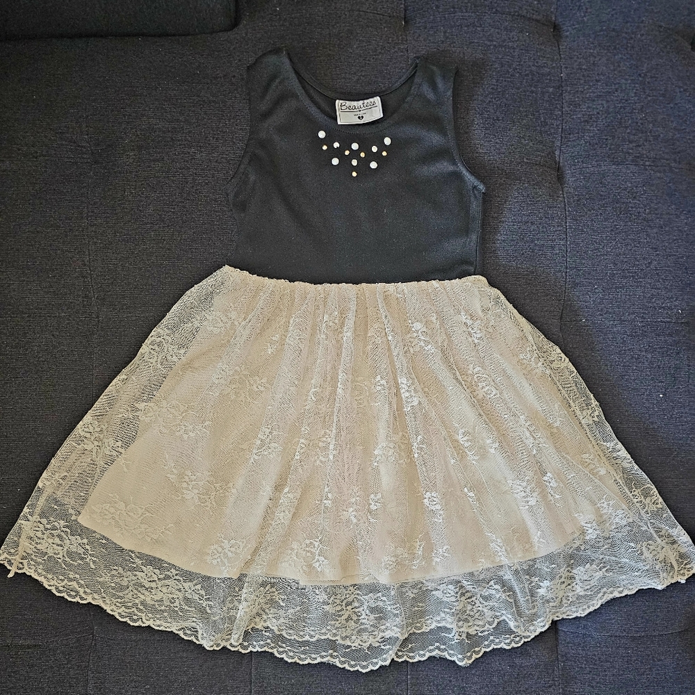 A beautiful black and cream lace dress for a little girl, size 5.